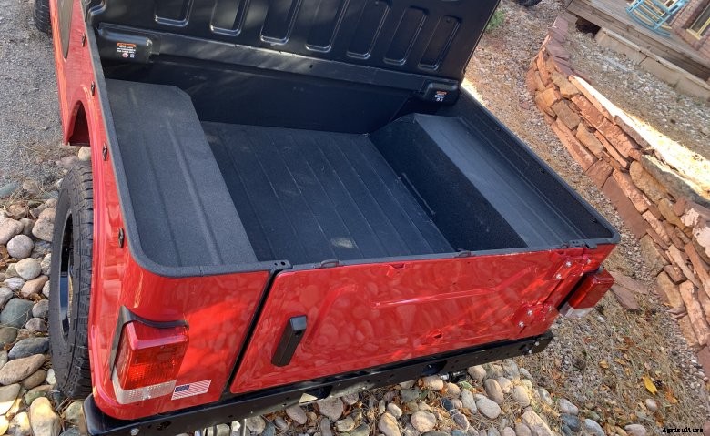 A red Mahindra Roxor cargo box